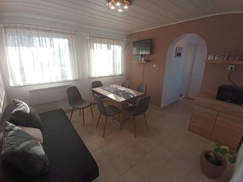 a living room with a table and chairs at Plázs Vendégházak 1 ,2 in Tiszafüred