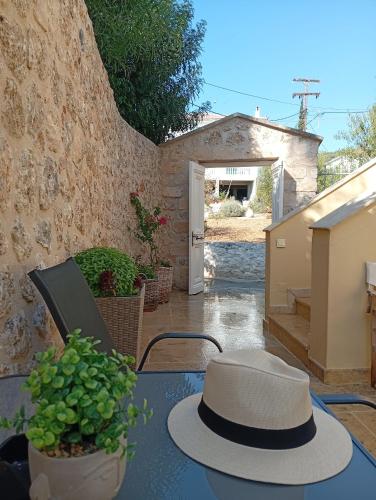 a hat sitting on a table in a patio at Vivi's Apartments Loft in Spetses