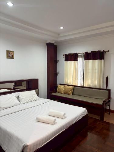 a bedroom with a bed with two towels on it at Mireya Resort Khaoyai in Ban Khanong Phra Nua