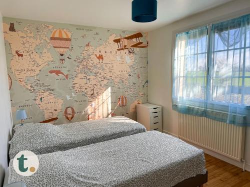 a bedroom with a bed and a map of the world at Tranquiloue - Maison de Campagne - PuyduFou in Treize-Vents