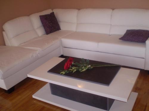 a living room with a white couch and a table at Villa Jelena in Zadar