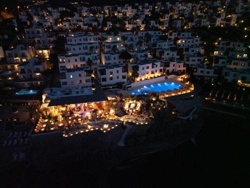 a view of a city at night with a pool at YAZ Yalıkavak in Yalıkavak