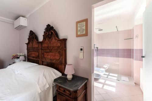 a bedroom with a bed and a bathroom with a shower at Albergo Diffuso Ca' Spiga in Laglio