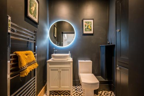 a bathroom with a sink and a mirror at The Leiston, Valley Road in Leiston