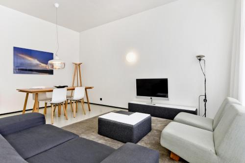 a living room with a couch and a table at Urban Residences Maastricht in Maastricht