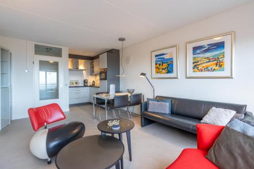 a living room with a couch and a table at Appartementencomplex Juliana 152 in De Koog