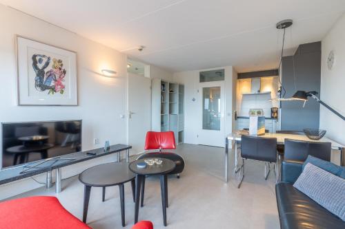 a living room with a couch and a table at Appartementencomplex Juliana 152 in De Koog