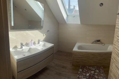 a bathroom with a sink and a bath tub at Apartmány U Stadionu in Šumperk