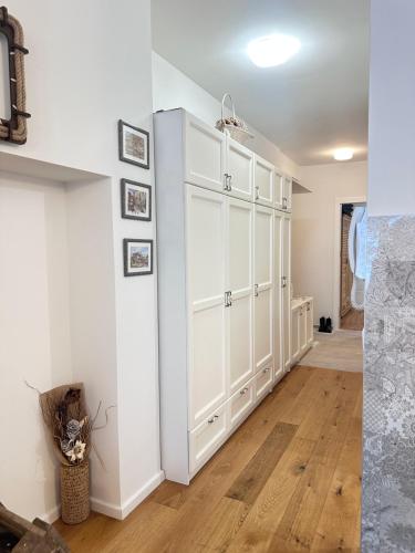 a room with a white cabinet and wooden floors at Planinski MIR Bjelašnica in Bjelašnica