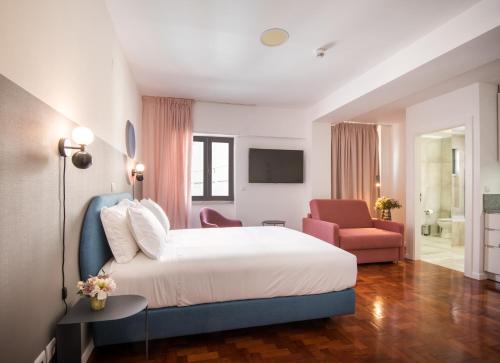 a hotel room with a bed and a chair at LSA Campos by Numa in Lisbon