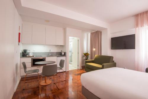 a hotel room with a bed and a kitchen at LSA Campos by Numa in Lisbon