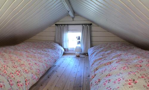 a bedroom with two beds and a window at Akurgerði Guesthouse 2 - Country Life Style in Ölfus