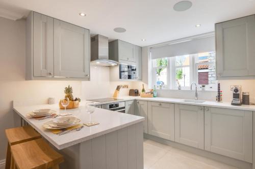 a kitchen with white cabinets and a large window at 3 Bed in Helmsley oc-y111 in Helmsley