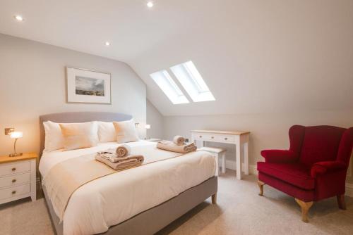 a bedroom with a bed and a red chair at 3 Bed in Helmsley oc-y111 in Helmsley