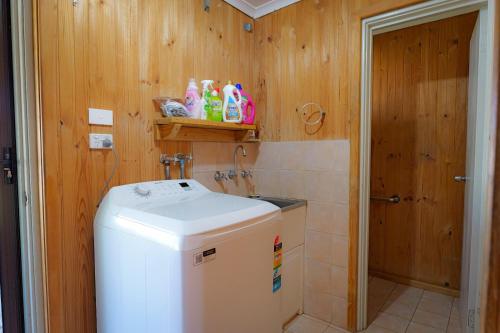 a small bathroom with a washer and dryer at Pamusha 2 in Geraldton
