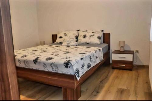 a bedroom with a bed and a night stand at MATEA Stay Imotski, Near Blue & Green Lake in Topići
