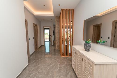 a hallway of a house with a mirror at Aurora 3 - Family Comfort near the beach in Marmari