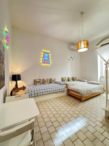 a living room with two beds and a window at La torretta del SUD in Bisceglie