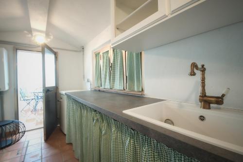 a bathroom with a large white sink and a window at Prugnolo Grand View in Montepulciano