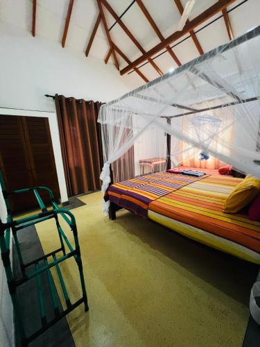 a bedroom with a bunk bed with a canopy at Jungle view one bedroom apartment in Unawatuna