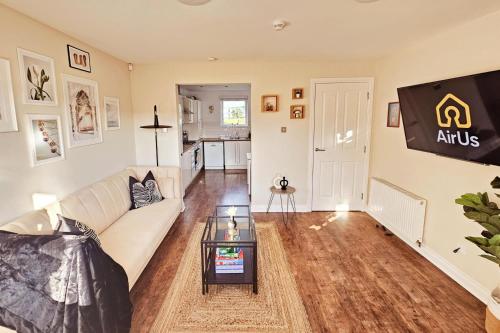 a living room with a couch and a table at Modern 5 Bedroom Townhouse with Free Parking in Glasgow