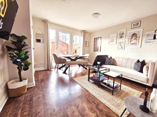 a living room with a couch and a table at Modern 5 Bedroom Townhouse with Free Parking in Glasgow