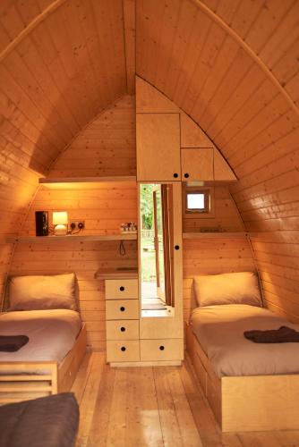 a small room with two beds and a window at Pinewood - At Port Lympne Hotel & Reserve in Hythe