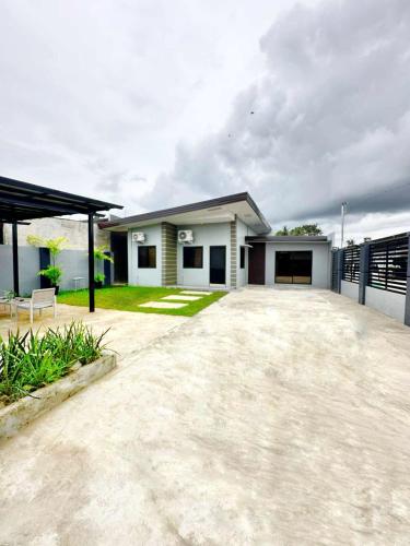 a house with a large driveway in front of it at Jumira Staycation in Tagum