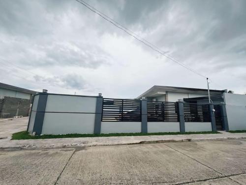 a building with a fence next to a street at Jumira Staycation in Tagum