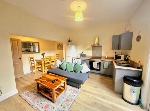 a living room with a couch and a table at City Stay - free parking in Worcester