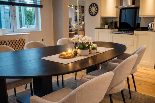 a dining room table with chairs and candles on it at Spacious 3-bed in Dulwich with parking in West Dulwich