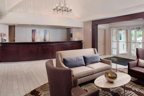 a living room with a couch and two chairs at Residence Inn Worcester in Worcester