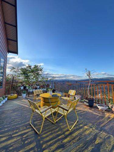 a patio with a table and chairs on a deck at Sen Đá Home 2 in Da Lat