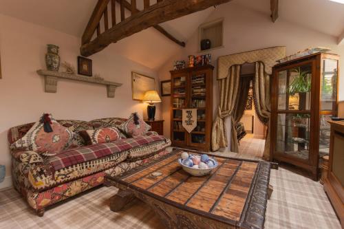 a living room with a couch and a table at Helmsley Garden Cottage & Railway Carriage in Helmsley