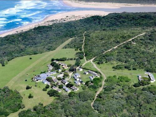 an aerial view of a group of houses on a hill near the ocean at THE HAVEN HOTEL in Mpume