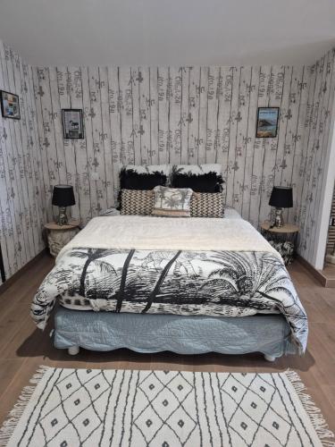 a bedroom with a bed and two tables with lamps at Gîte La Tchoupetta,proche Narbonne jaccuzi, jardin, canalplus, netflix in Peyriac-de-Mer