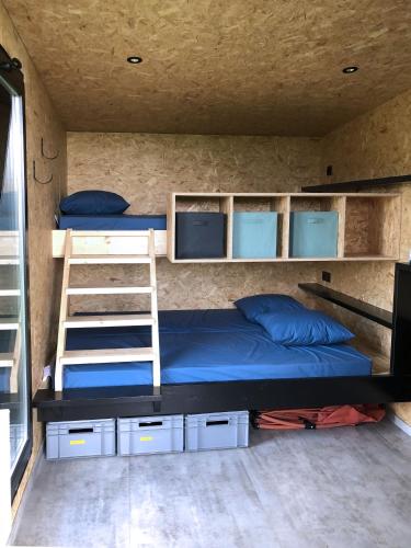 a room with two bunk beds and a ladder at Cyclodges – Marguerite et Ferdinand in Hotton