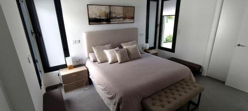 a bedroom with a large bed and two windows at Villa Mojacar in Mojácar