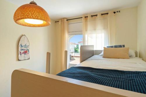 a bedroom with a bed and a large window at Brisa I Apartment in Montroig