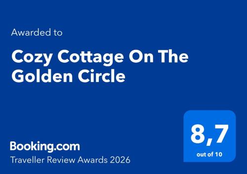 a blue logo with the words cozy cottage on the golden circle at Cozy Cottage On The Golden Circle in Blaskogabyggo
