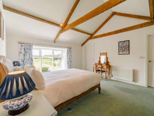 a bedroom with a large bed and a window at 3 Bed in Belford oc-89518 in Belford