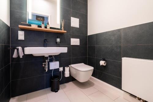 a bathroom with a sink and a toilet at Marios Mansion in Leipzig