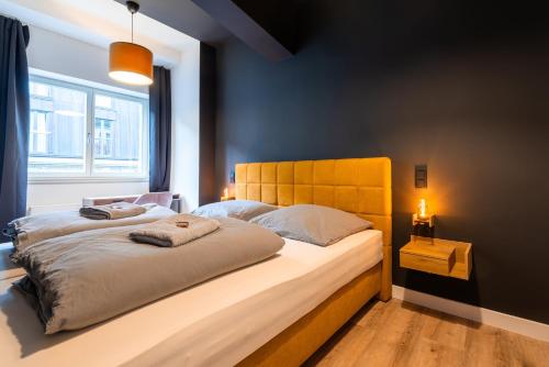 a bedroom with a large bed with a wooden headboard at Marios Mansion in Leipzig