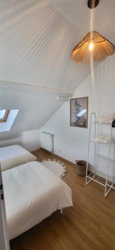 a bedroom with two beds and a white ceiling at Maison cosy 4-6 pers avec terrasse Lac & hyper centre à pied 300 m Linge inclus in Gérardmer