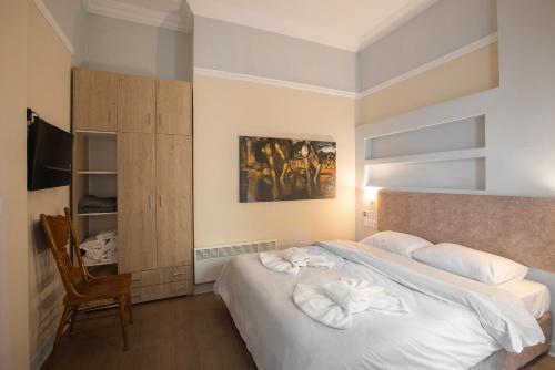 a bedroom with a bed with white towels on it at vintege style apartment in Thessaloniki