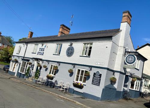 a white building on the corner of a street at The Star Inn 1744 in Thrussington