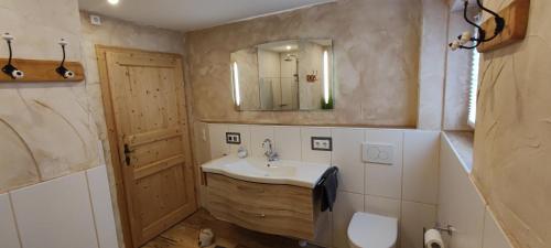 a bathroom with a sink and a mirror at Chalet Edelweiß in Achenkirch