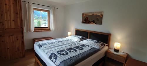 a bedroom with a bed and a window at Chalet Edelweiß in Achenkirch