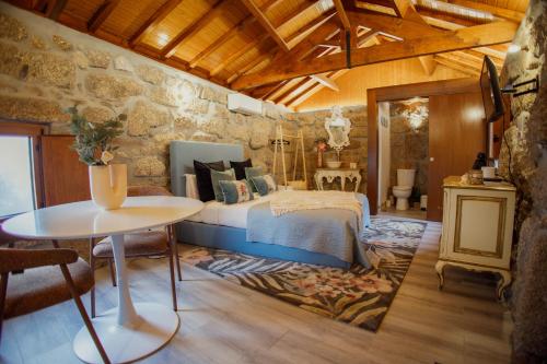 a bedroom with a bed and a table at Refúgios da Natureza in Entre-os-Rios