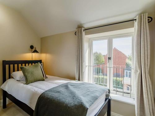 a bedroom with a bed and a large window at 3 Bed in Saxmundham oc-89691 in Aldringham